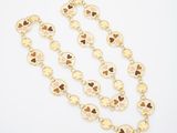 a gold necklace with hearts and hearts on it
