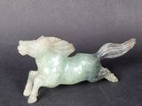 a small statue of a horse that is sitting on a table