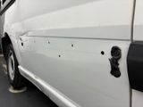 a white van with bullet holes on the side of it