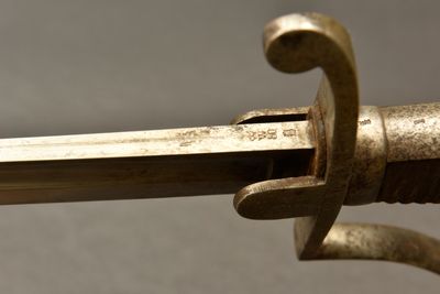 a close up of a sword with a metal handle
