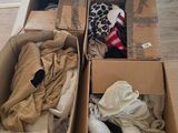 two boxes of clothes and a stuffed animal in them