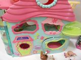 a little girl ' s play house with a dog and a cat