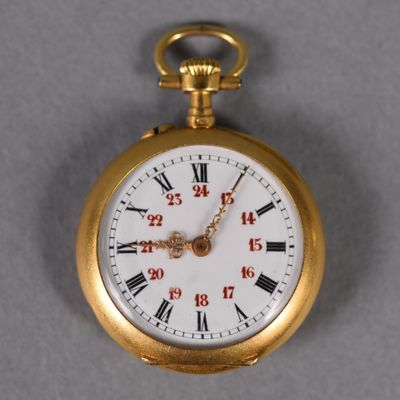 a gold pocket watch with roman numerals on it