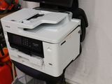 a printer sitting on top of a cart in a garage
