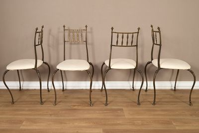 Trois chaises sont alignées contre un mur marron.