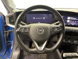 the interior of a car with a steering wheel and dashboard controls