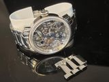 a watch that is sitting on a table next to a bracelet