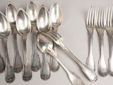 a lot of silver spoons and forks on the table