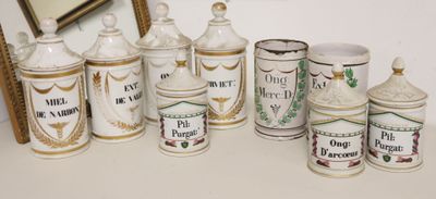 many different types of ceramic jars on the table