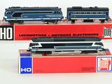 two trains sitting on top of each other on a table