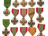 une image représentant un ensemble de médailles et de croix sur fond blanc