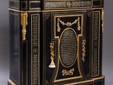 an antique black and gold painted cabinet with a marble top
