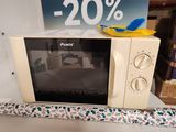 a microwave sitting on a counter with a 20 % sale sign in the background