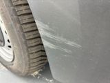 a close up of a car ' s tire with a dirty paint job on it