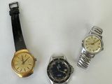 three different types of watches are displayed on a white surface