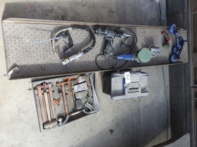 many tools and tools on the floor of a garage