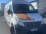 an orange and white van parked in a parking lot next to a building