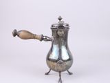 an antique silver coffee pot with a wooden handle on a white background