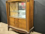 an antique wooden display cabinet with glass doors and drawers