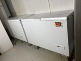 a white chest freezer sitting in the corner of a room