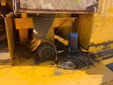 a yellow machine that is sitting on the side of the road