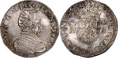 a silver coin with an image of a man in a crown on it