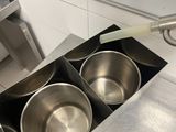 four bowls in the middle of a stainless steel stove