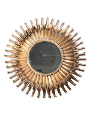 an image of a gold sunburst on a white wall