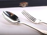 a fork and a spoon sitting on a table