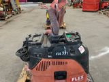 a red machine that is sitting on a pallet in a warehouse
