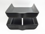 two black plastic trays are stacked on top of each other