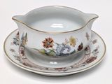 a bowl and saucer sitting on a saucer on a plate