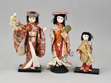 three asian dolls of women in kimono and geisha outfits