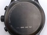 the back of a watch with a black face and brown leather strap