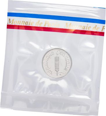 a close up of a coin in a plastic bag on a white background