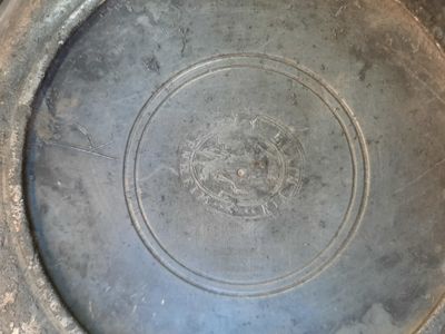 a large metal bowl with a circular design on it