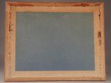 an old picture frame is sitting on a table with a gray background