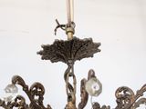 a chandelier that has a candle on top of it