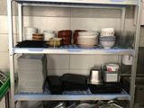 many pots and pans on the shelves in the kitchen