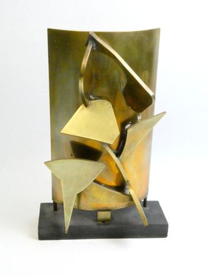 a metal sculpture of a bird on top of a base