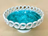 a white bowl with a blue bowl inside of it