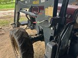 a tractor that is parked in the dirt