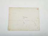 an old envelope with a stamp on it sitting on top of a table