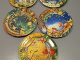 six decorative plates with different designs on them sitting on a table