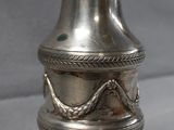 an antique silver vase with a snake on it on a table