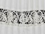 close up of a white dress with a black and white lace trim