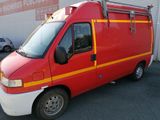 an image of a red and yellow fire truck parked in front of a building