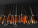 several different types of knives are lined up on a black surface