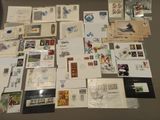 many different types of stamps and postcards laid out on a table