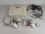 a game console with two controllers and a charger